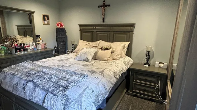 a bed sitting in a bedroom next to a window