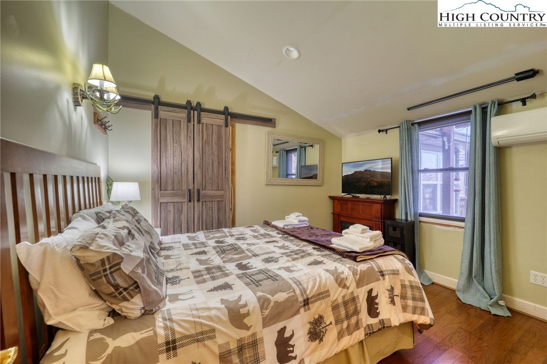 72 Arnett Road Banner Elk, NC 28604 - Photo 18 of 38 a bedroom with a bed mirror and a window