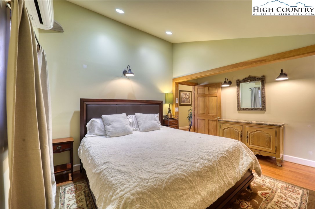 72 Arnett Road Banner Elk, NC 28604 - Photo 24 of 38 a large bedroom with a bed and wooden floor