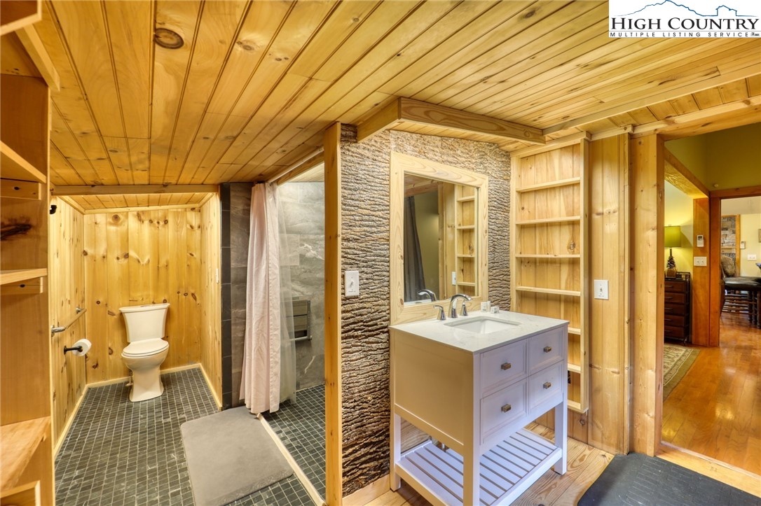 72 Arnett Road Banner Elk, NC 28604 - Photo 25 of 38 a bathroom with a sink and mirror with bathtub