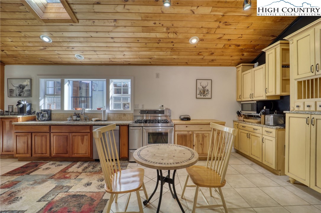 72 Arnett Road Banner Elk, NC 28604 - Photo 7 of 38 a kitchen with appliances cabinets and chair