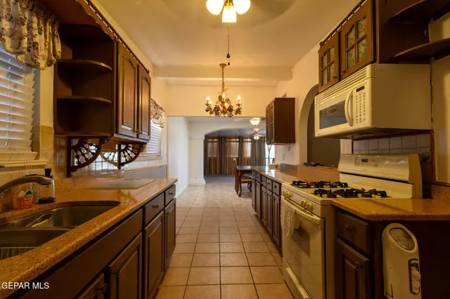 a kitchen with stainless steel appliances granite countertop a sink and stove