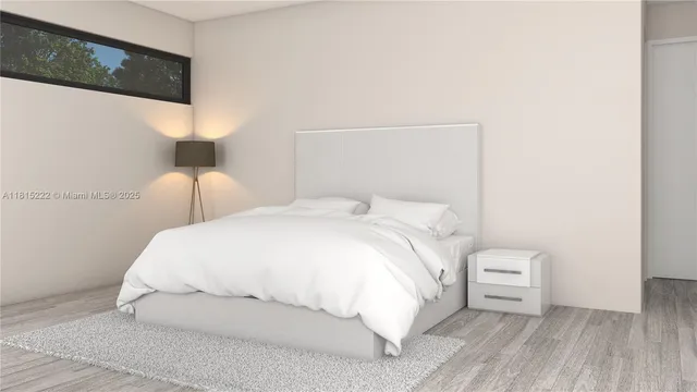 a large white bed in a white room
