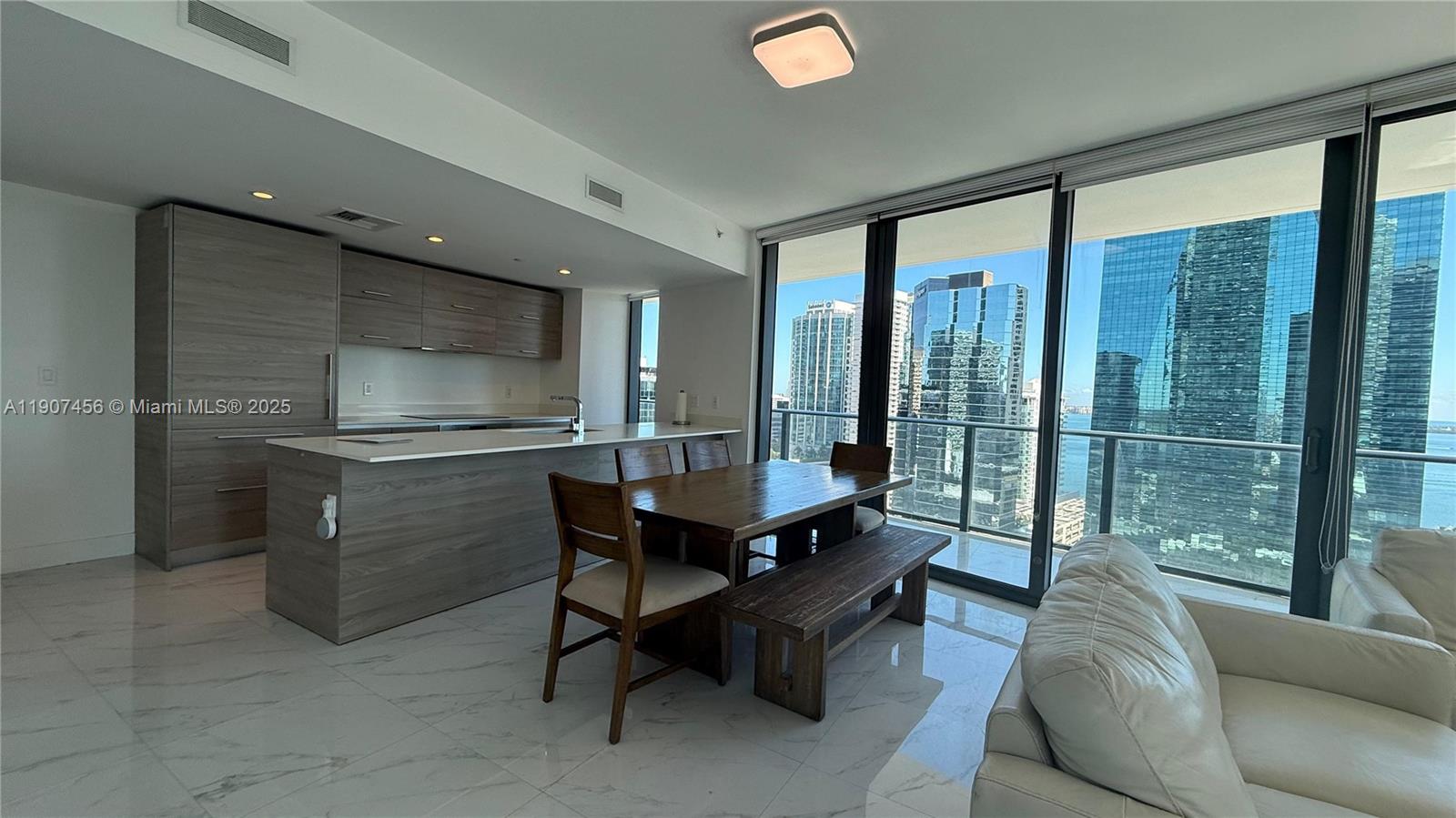 1300 South Miami Avenue, Unit 2005 Miami, FL 33130 - Photo 13 of 46 a living room with furniture and a floor to ceiling window
