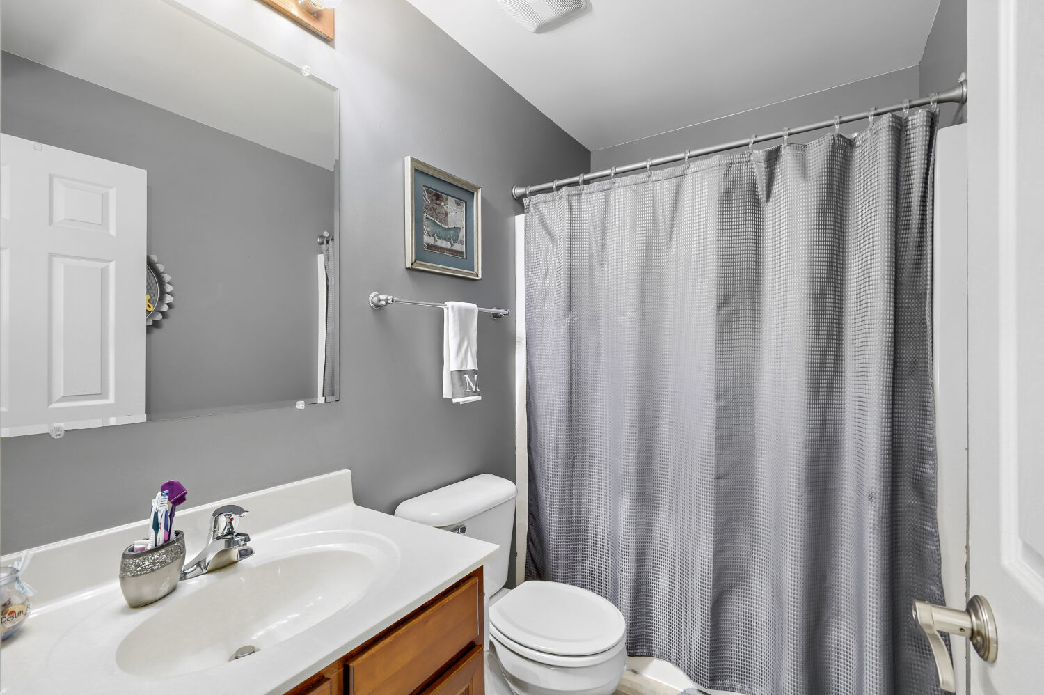 422 Victoria Lane Elgin, IL 60124 - Photo 14 of 22 a bathroom with a sink a toilet and shower curtain