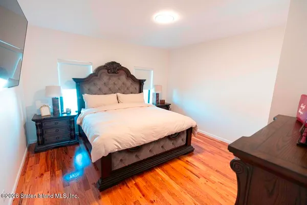 a bedroom with a bed and a dresser
