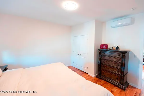 a bedroom with a bed and chair