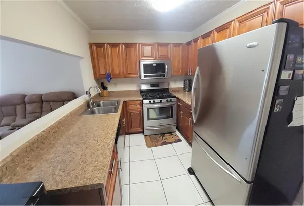 a kitchen with granite countertop a stove and a sink