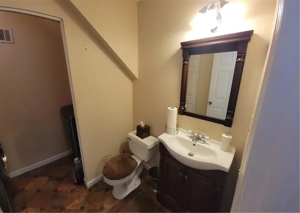 a bathroom with a sink a mirror and vanity
