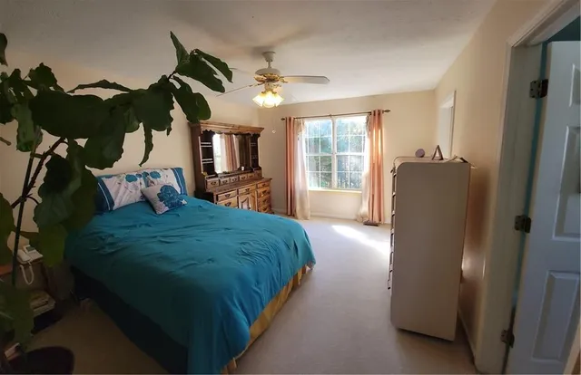 a bedroom with a bed and a mirror