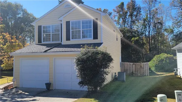 a front view of a house with a yard