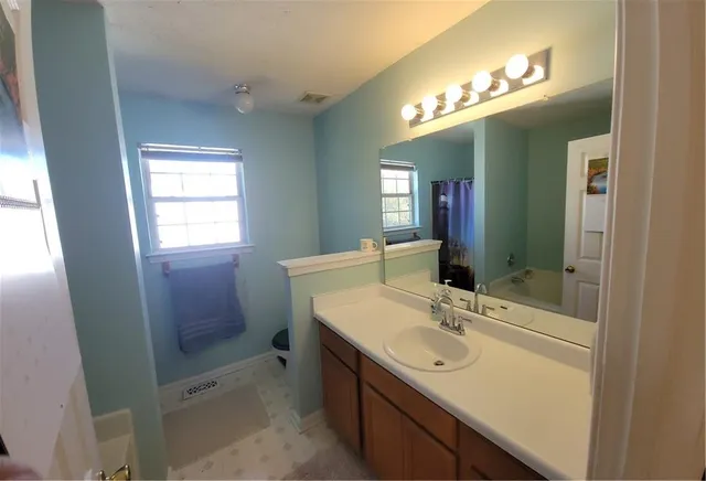 a bathroom with a sink vanity and a mirror