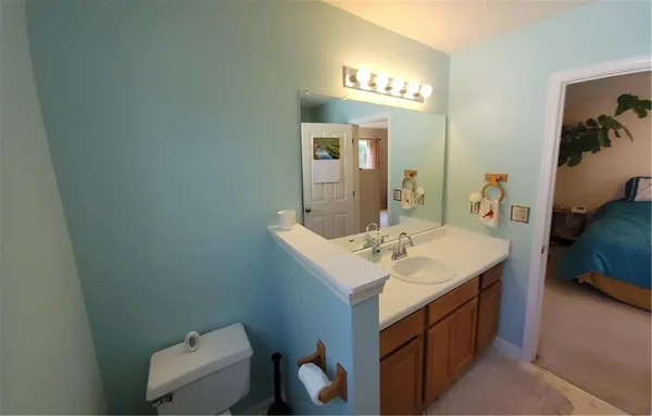a en suite bathroom with a sink and a mirror