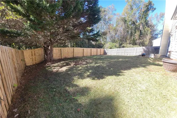 a view of a house with a yard and a garden