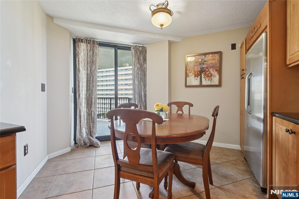 245 Prospect Avenue, Unit 5B Hackensack, NJ 07601 - Photo 11 of 35 a view of a dining room with furniture and a window