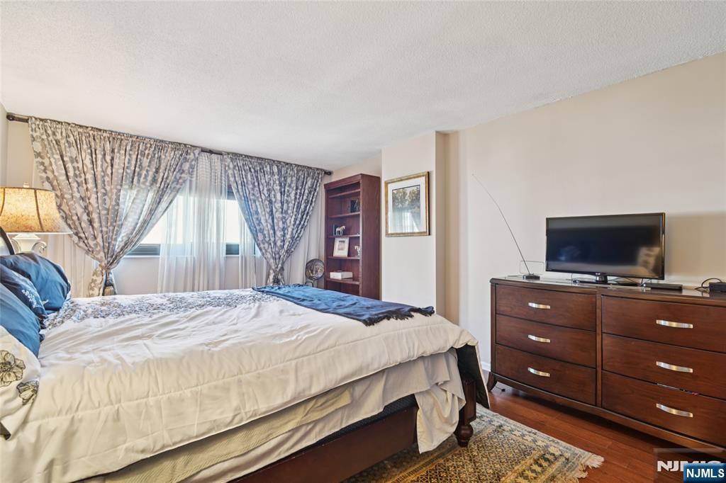 245 Prospect Avenue, Unit 5B Hackensack, NJ 07601 - Photo 12 of 35 a bedroom with a bed and a television