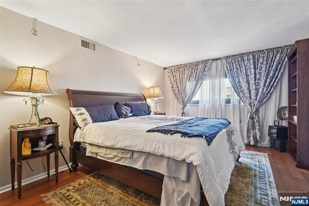 245 Prospect Avenue, Unit 5B Hackensack, NJ 07601 - Photo 13 of 35 a bedroom with a bed and lamp