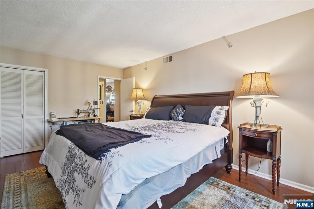 245 Prospect Avenue, Unit 5B Hackensack, NJ 07601 - Photo 14 of 35 a bedroom with bed and a night stand