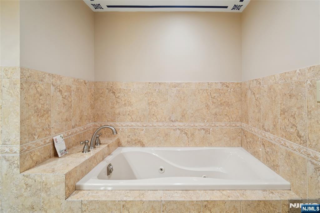 245 Prospect Avenue, Unit 5B Hackensack, NJ 07601 - Photo 19 of 35 a bathroom with a tub