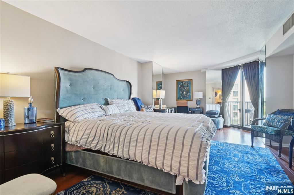 245 Prospect Avenue, Unit 5B Hackensack, NJ 07601 - Photo 20 of 35 a bedroom with a bed and wooden floor