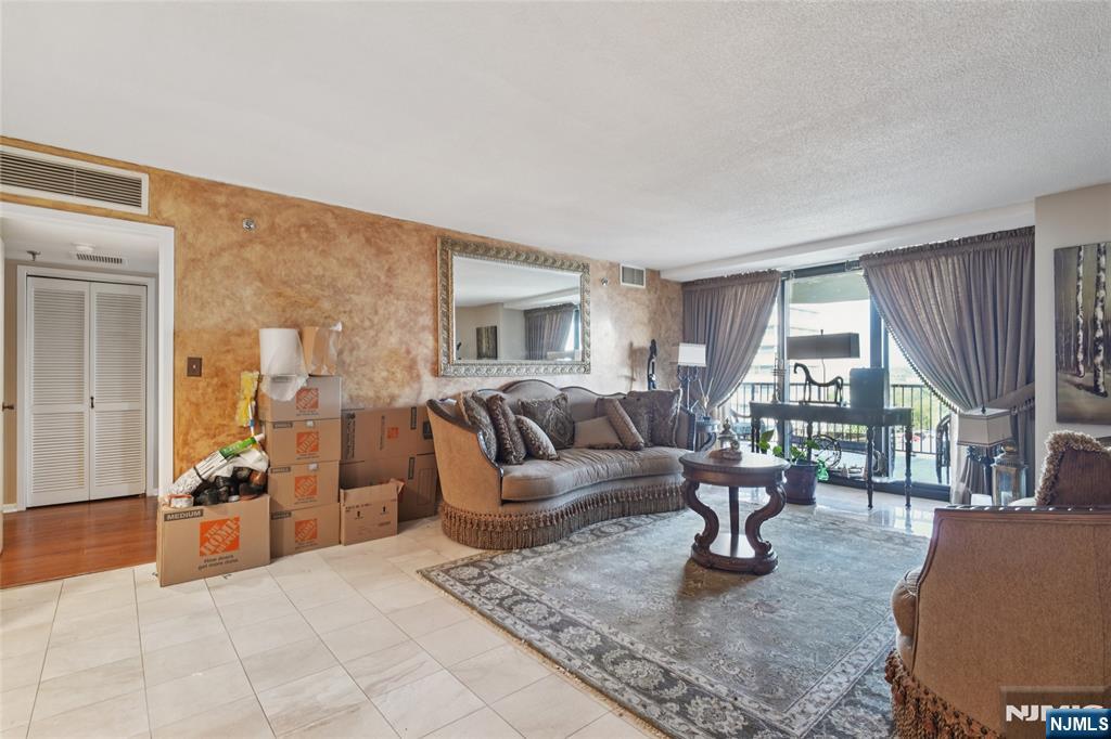 245 Prospect Avenue, Unit 5B Hackensack, NJ 07601 - Photo 2 of 35 a living room with furniture and a large window