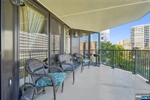 a balcony with furniture and a potted plant
