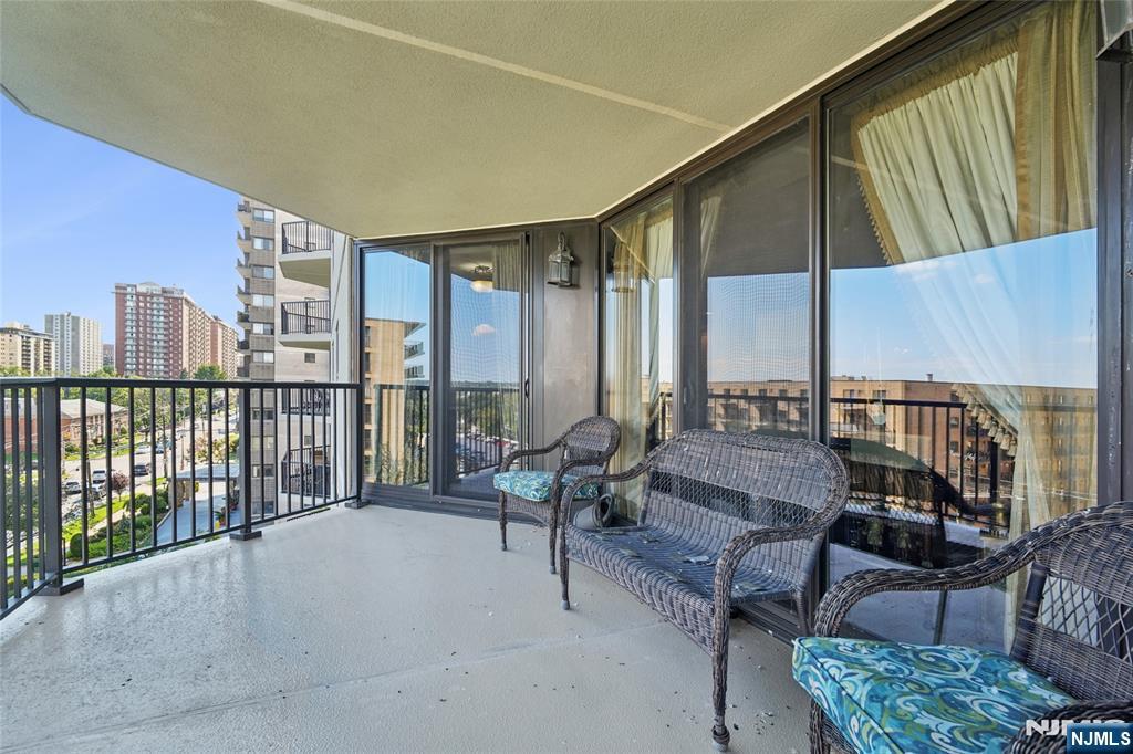 245 Prospect Avenue, Unit 5B Hackensack, NJ 07601 - Photo 24 of 35 a living room with furniture and a floor to ceiling window