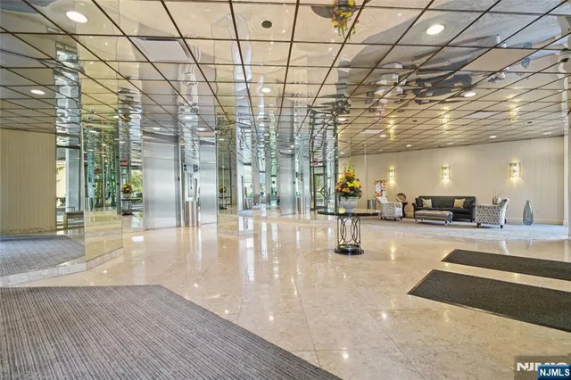 a lobby with furniture and floor to ceiling windows