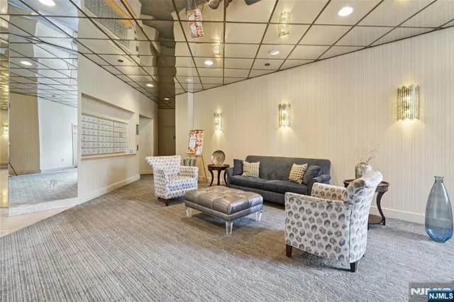 a living room with furniture and a chandelier