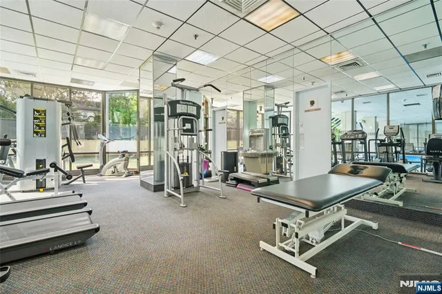 a living room with large windows and a table