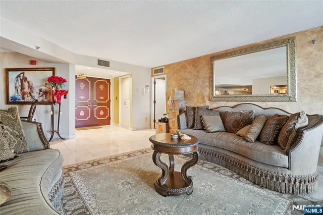 a living room with furniture and a painting