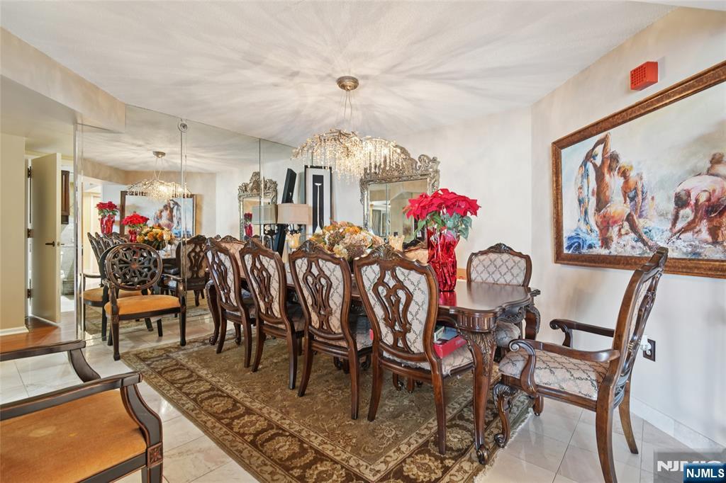 245 Prospect Avenue, Unit 5B Hackensack, NJ 07601 - Photo 5 of 35 a view of a dining room with furniture and chandelier
