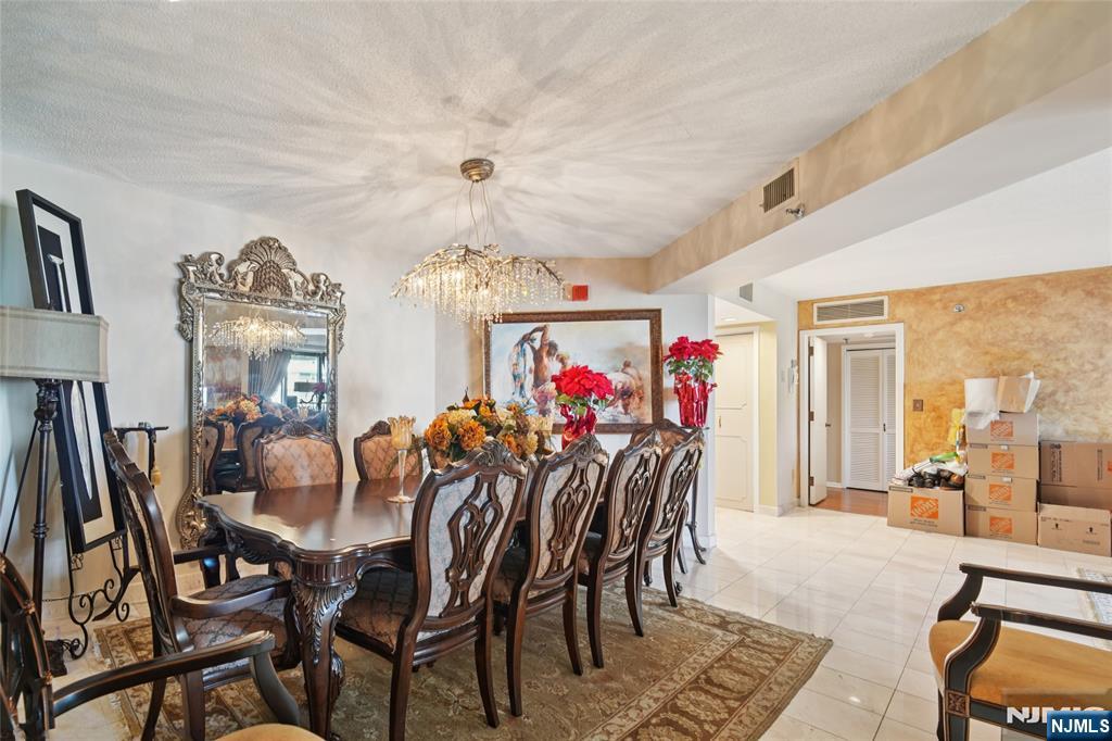 245 Prospect Avenue, Unit 5B Hackensack, NJ 07601 - Photo 6 of 35 a view of a dining room with furniture and a chandelier