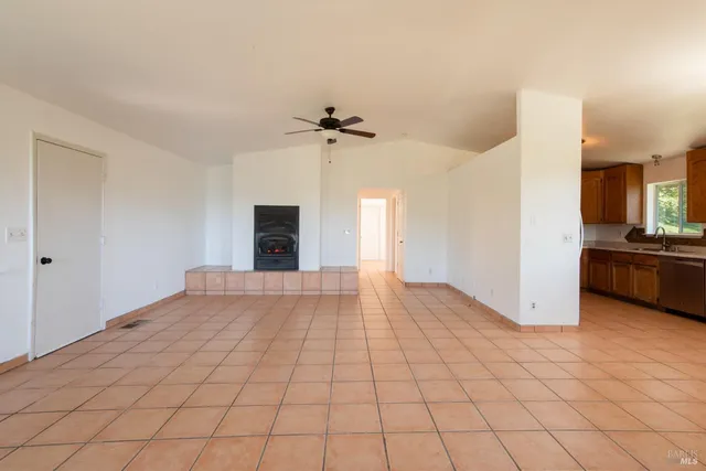a view of a kitchen with cabinet and a fireplace