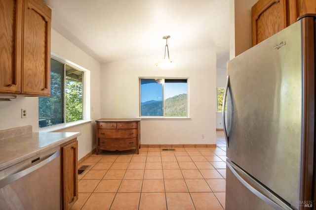 a kitchen with granite countertop a refrigerator and a sink