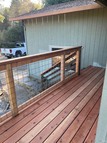a view of a balcony with wooden floor and outdoor space