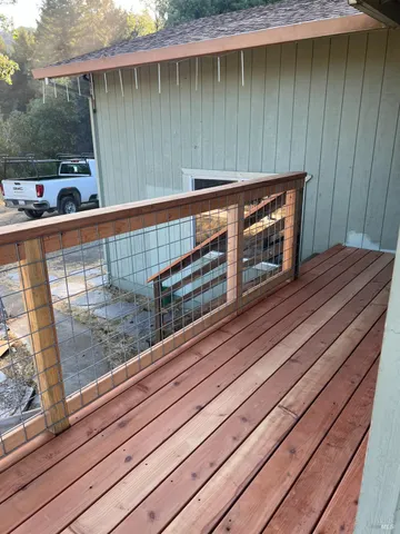 a view of a balcony with wooden floor and outdoor space