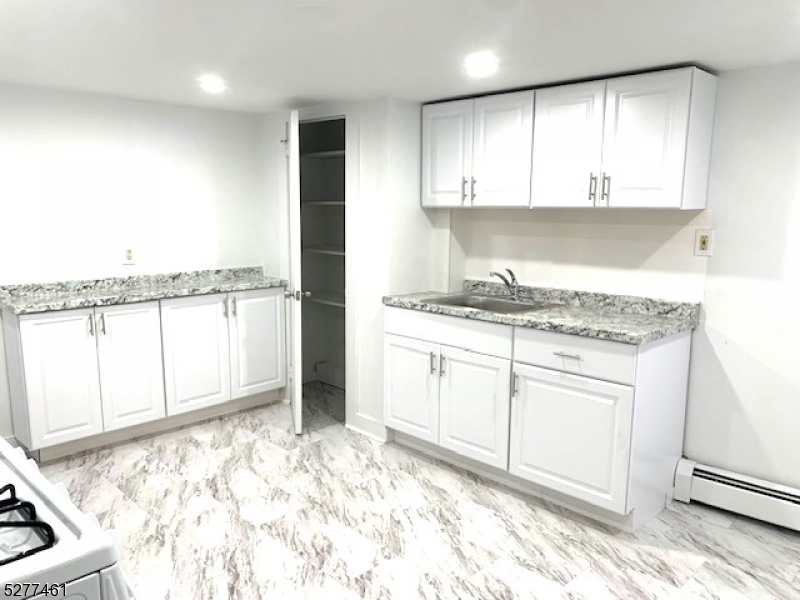 a kitchen with granite countertop white cabinets and a granite counter tops