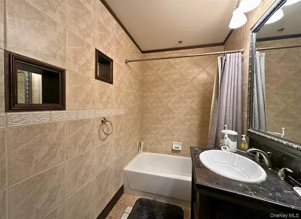 a bathroom with a granite countertop sink a mirror and a shower