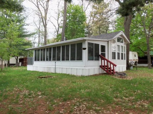 a view of a house with a yard and deck