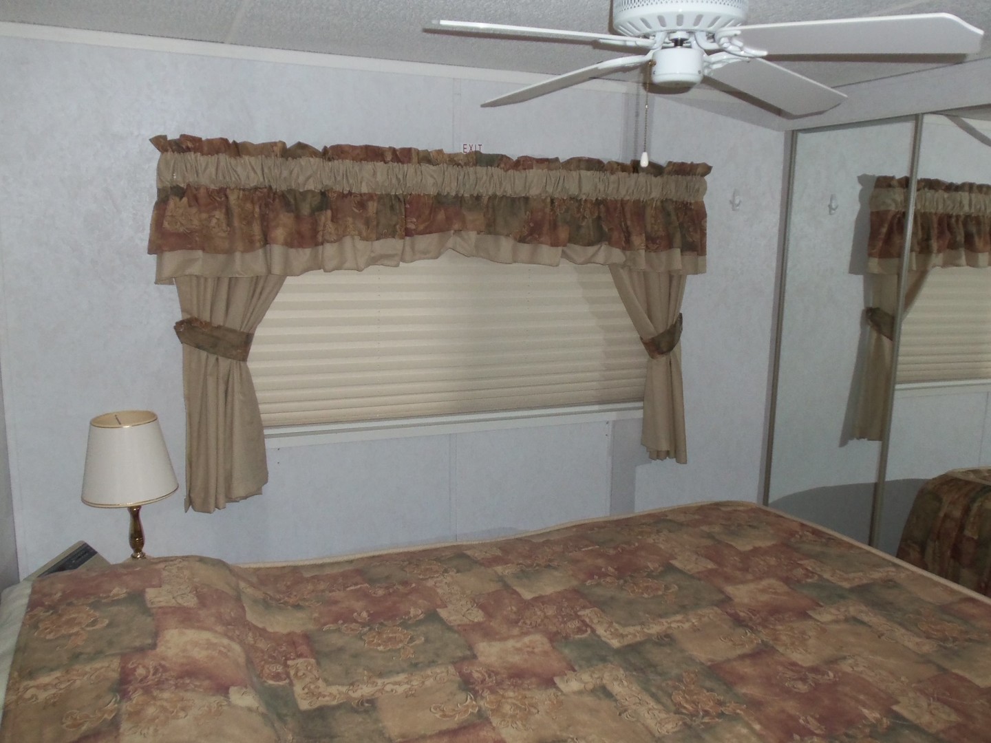 7-150 Woodhaven Sublette, IL 61367 - Photo 12 of 16 a bedroom with a bed and a chandelier