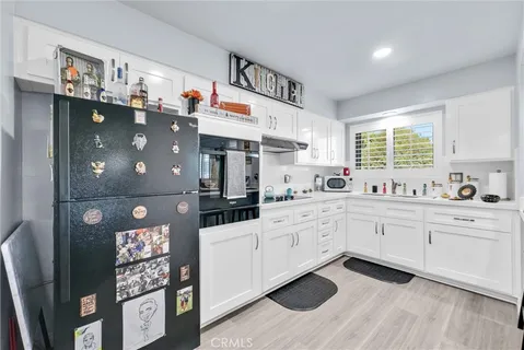 a kitchen with a sink appliances and cabinets