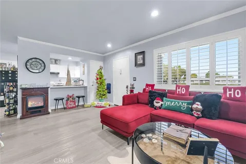 a living room with furniture a fireplace and a large window