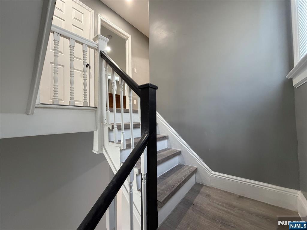 188 Teaneck Road Ridgefield Park, NJ 07660 - Photo 7 of 13 a view of staircase with wooden floor and white walls
