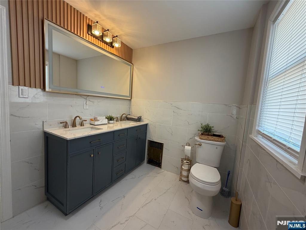 188 Teaneck Road Ridgefield Park, NJ 07660 - Photo 8 of 13 a bathroom with a sink vanity mirror and toilet