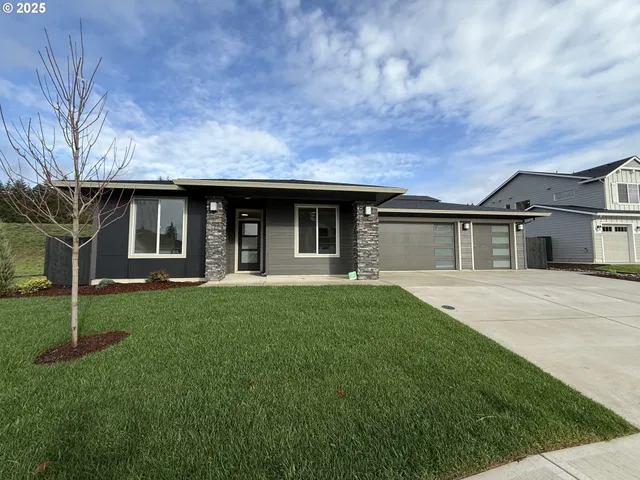 a front view of a house with a garden