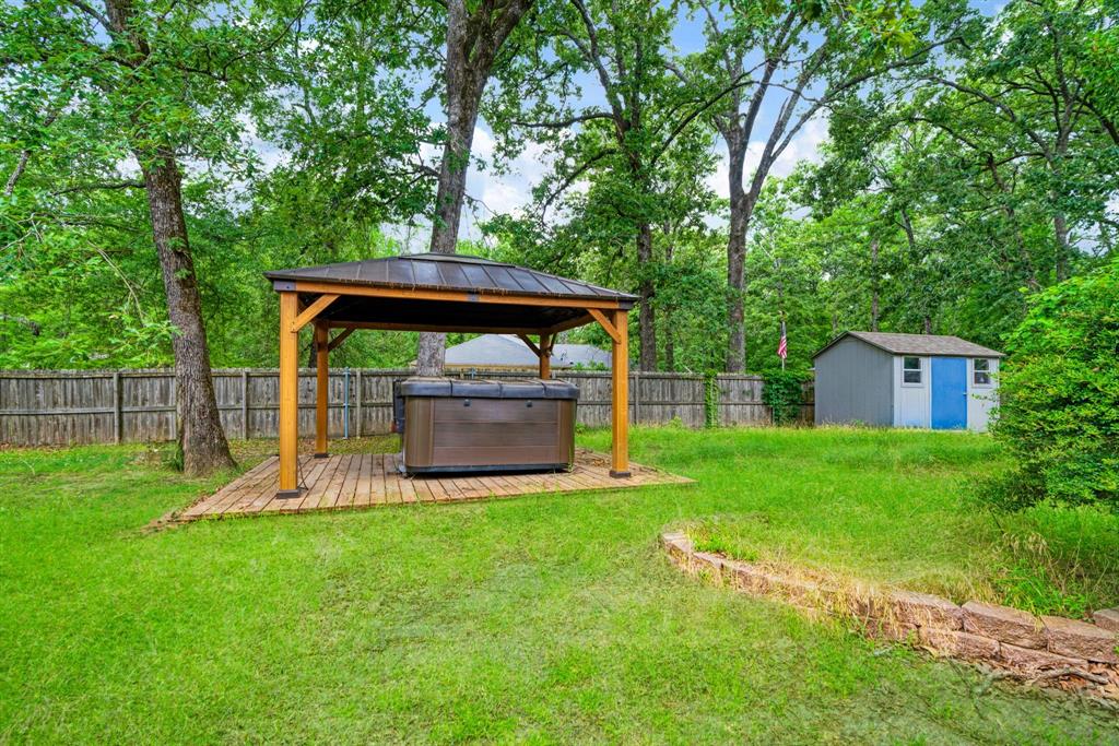 455 Timber Lakes Drive Powderly, TX 75473 - Photo 15 of 18 a view of a garden with a trampoline