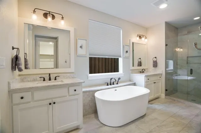 a bathroom with a bathtub sink and mirror