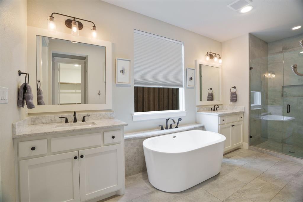 313 East 3rd Street Prosper, TX 75078 - Photo 16 of 38 a bathroom with a bathtub sink and mirror