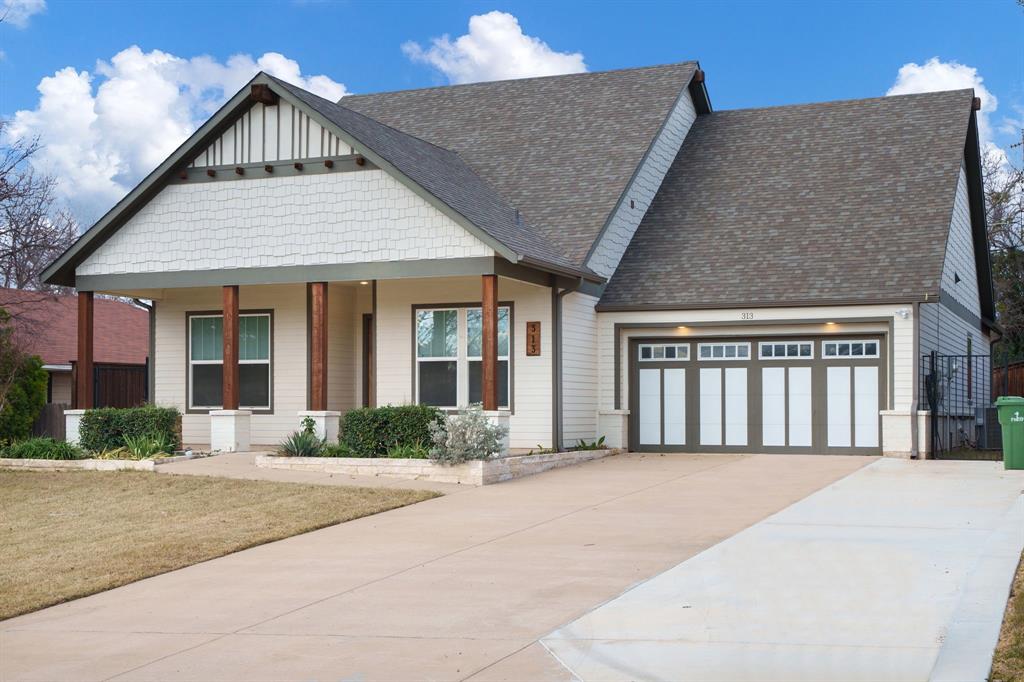 313 East 3rd Street Prosper, TX 75078 - Photo 2 of 38 a front view of a house with large windows